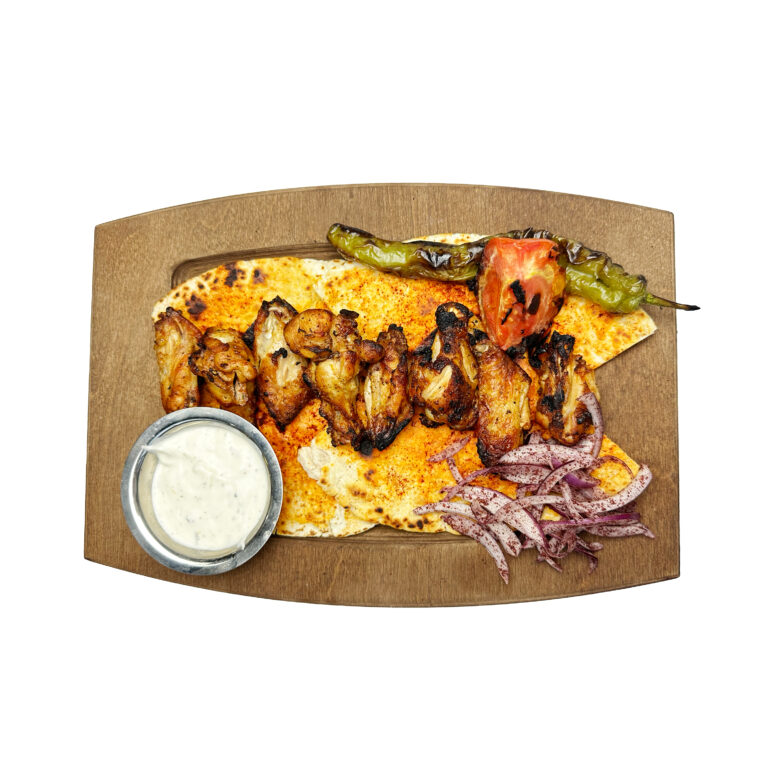 Mixed grill skewers on a wooden board at Baba&rsquo;s Kitchen, Atlanta