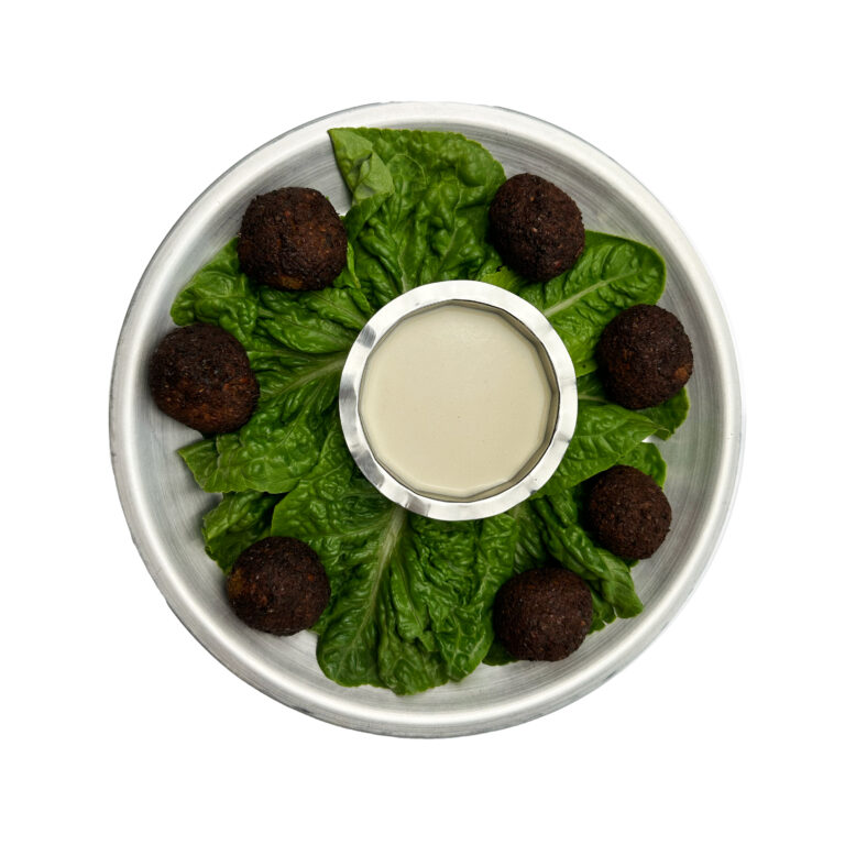 Falafel with tahini on a bed of herbs